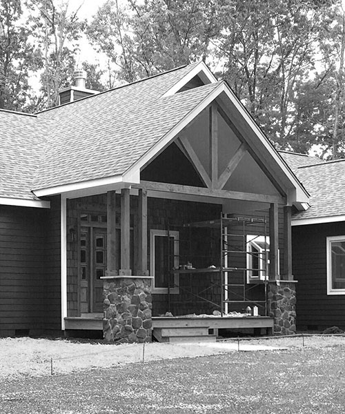 A single-story bungalow with a gabled roof, covered porch, and a small front garden.