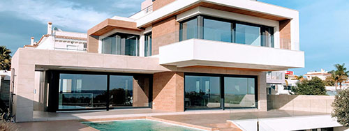 A modern two-story white house located in Orlando, featuring clean lines, large windows, and a minimalist architectural design.